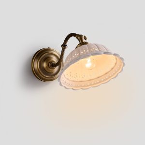 French Country Wall Sconce with antique brass arm and scalloped pierced ceramic shade
