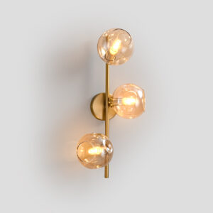 Front view of a 3-light modern brass wall sconce with amber glass globes.